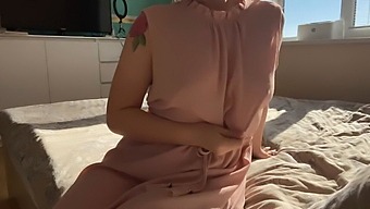A Woman In A Feminine Pink Dress Indulges In Self-Pleasure